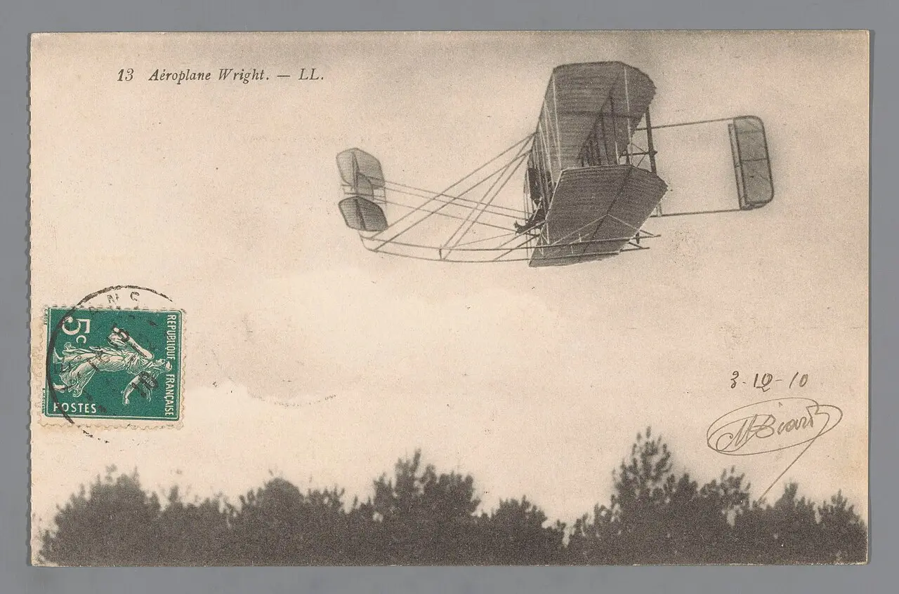 A circa-1908 French postcard showing a Wright brothers aeroplane in flight; Wilbur Wright first flew publicly in France at Le Mans on August 8, 1908.