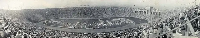 Panoramic view of a packed Los Angeles Memorial Coliseum on opening day, July 30, 1932, with athletes massed on the field for the Xth Olympiad.