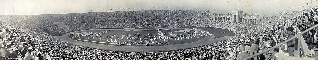 Panoramic view of a packed Los Angeles Memorial Coliseum on opening day, July 30, 1932, with athletes massed on the field for the Xth Olympiad.