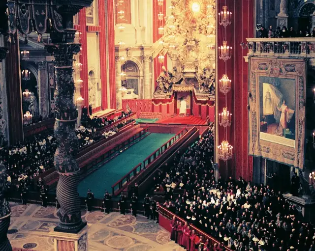 Photograph by Lothar Wolleh of the Second Vatican Council in session inside St. Peter's Basilica, with thousands of bishops in white vestments seated in long rows beneath the great dome.