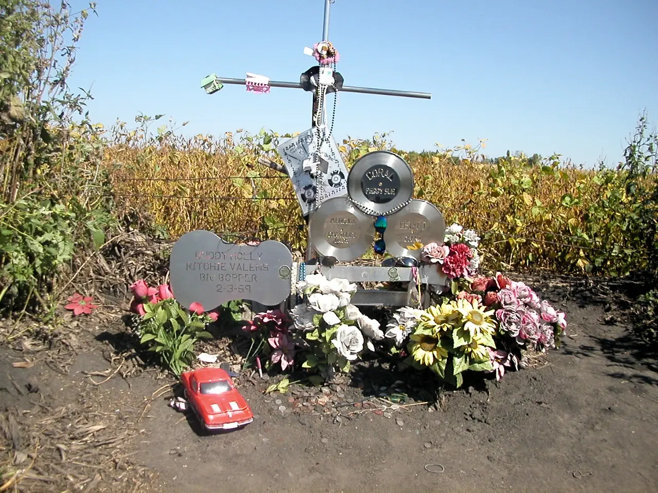 The guitar-shaped memorial at the Clear Lake, Iowa crash site, bearing the names Buddy Holly, Ritchie Valens, and the Big Bopper and the date 2-3-59.