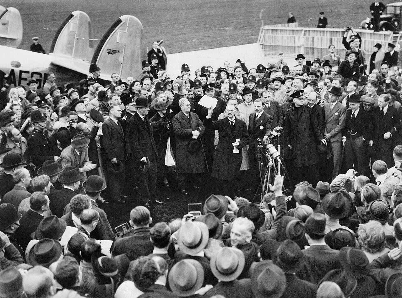 Neville Chamberlain holding up the signed Munich Agreement before a crowd at Heston Aerodrome on September 30, 1938.