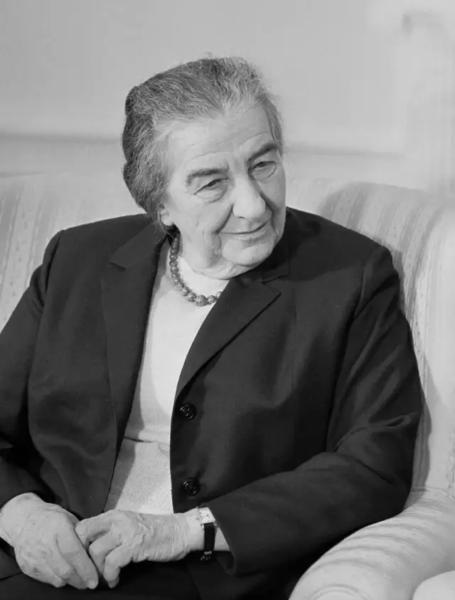 Black-and-white portrait of Golda Meir seated and smiling, photographed in the 1960s.
