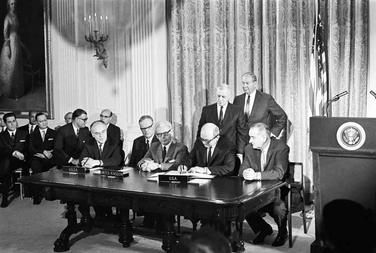 The Outer Space Treaty signing ceremony on January 27, 1967, with delegates seated at a long table (historic photograph).
