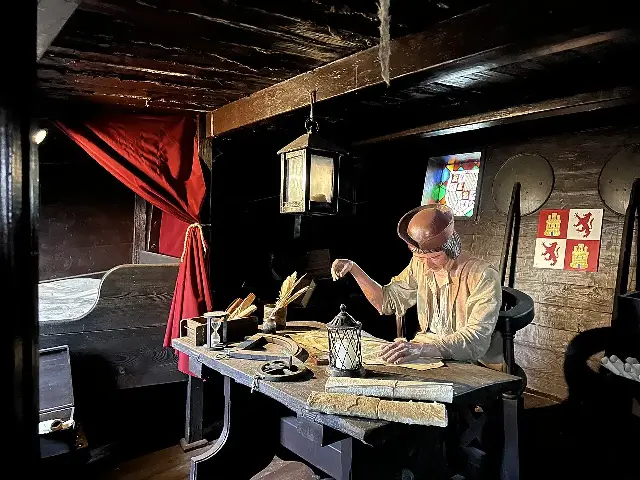 A recreated captain's cabin aboard one of the full-size replica caravels at the Muelle de las Carabelas in Palos de la Frontera, Spain, with a figure of Columbus at his charts.