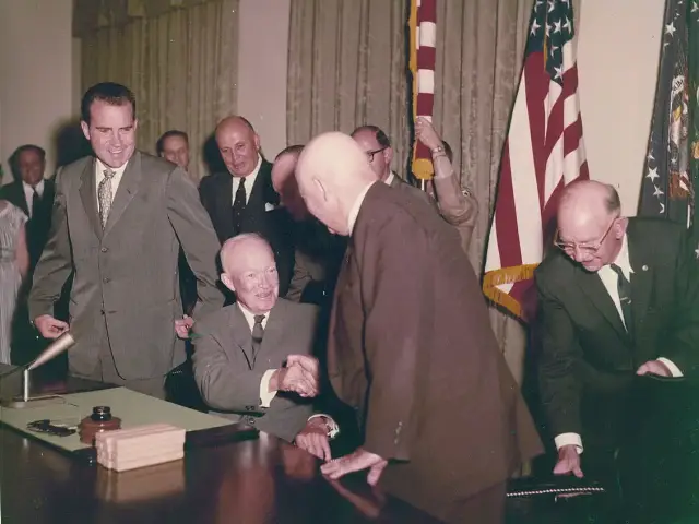 President Dwight D. Eisenhower signing the proclamation admitting Hawaii as the 50th state on August 21, 1959, with Vice President Richard Nixon looking on.