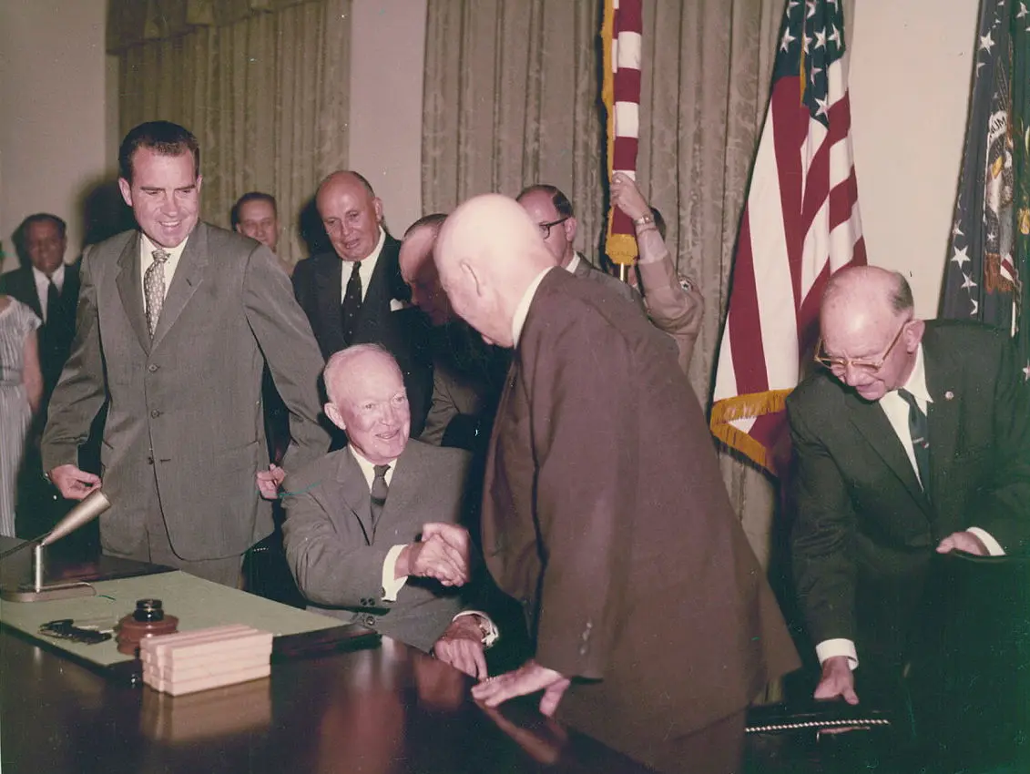 President Dwight D. Eisenhower signing the proclamation admitting Hawaii as the 50th state on August 21, 1959, with Vice President Richard Nixon looking on.