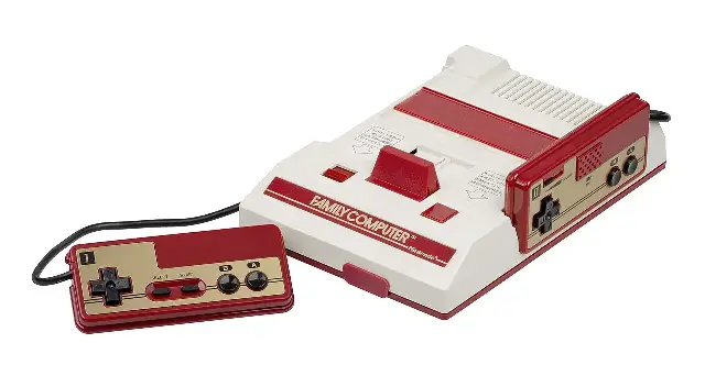 The original Nintendo Family Computer (Famicom) console in its red-and-white design with a controller.