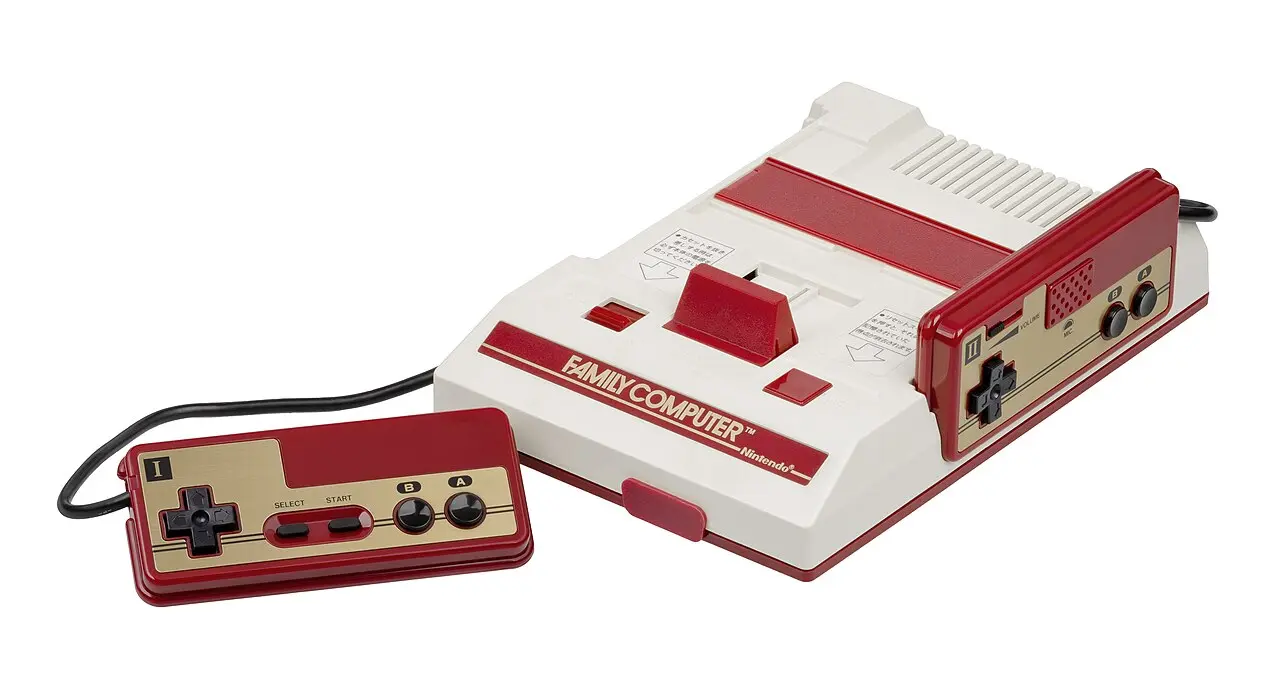 The original Nintendo Family Computer (Famicom) console in its red-and-white design with a controller.