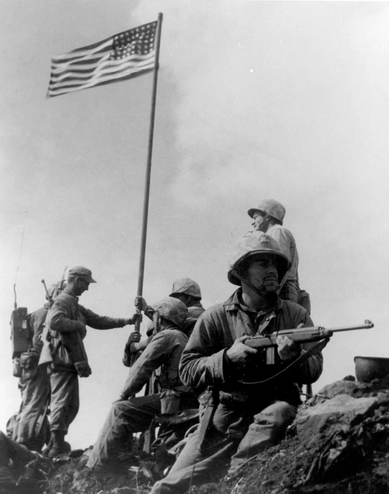 U.S. Marines raising the first American flag atop Mount Suribachi, Iwo Jima, on February 23, 1945