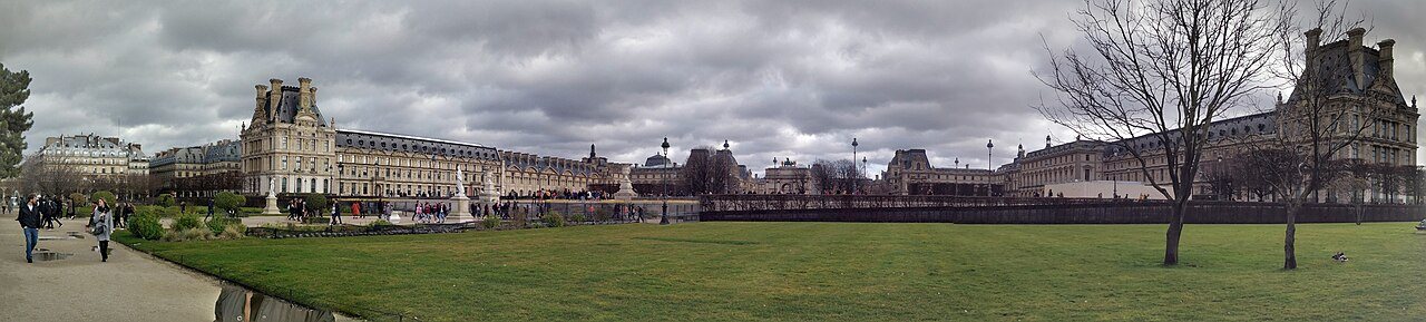 A panoramic view of the Louvre Museum complex in Paris, seen from the Tuileries Garden.