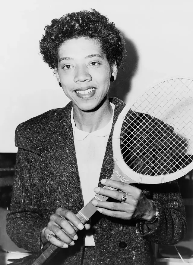 Althea Gibson holding a tennis racquet in 1956, the year before her Wimbledon triumph