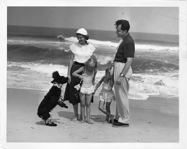 Richard Nixon with his wife Pat, their daughters, and Checkers the cocker spaniel on a New Jersey beach
