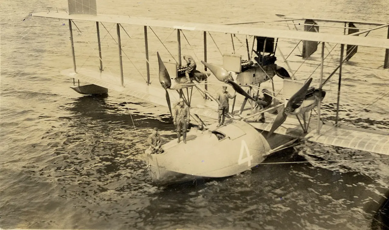 The Navy flying boat NC-4 floating on the water with its crew.