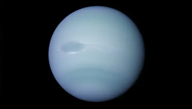 Neptune photographed by NASA's Voyager 2 spacecraft in 1989, showing the Great Dark Spot storm