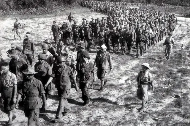 Captured French soldiers being marched to a prisoner camp after the fall of Dien Bien Phu, May 1954