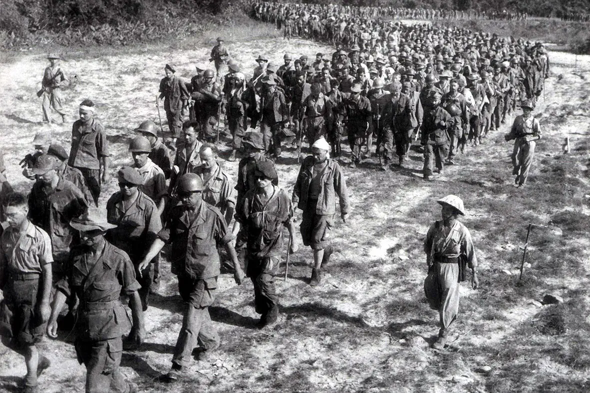 Captured French soldiers being marched to a prisoner camp after the fall of Dien Bien Phu, May 1954
