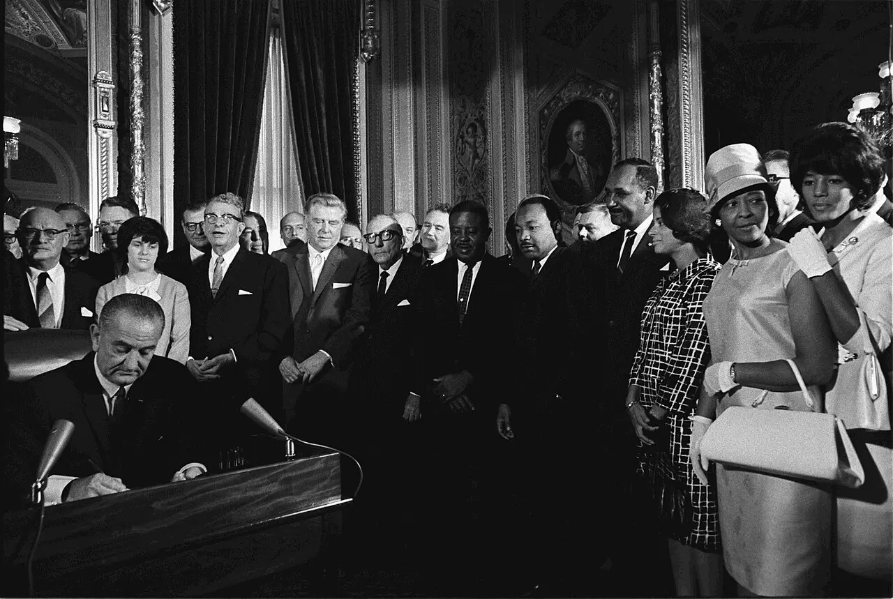 President Lyndon B. Johnson signs the Voting Rights Act of 1965 as Martin Luther King Jr. and other civil rights leaders look on, August 6, 1965.