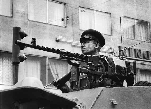 A Soviet soldier with a machine gun on an armored scout car in Prague during the Warsaw Pact invasion, August 1968.