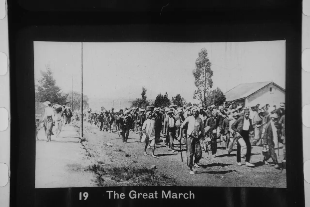 A 1913 lantern slide labeled 'The Great March' showing Indian marchers on the road in South Africa.