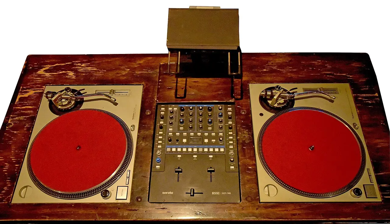 Illustrative image: a modern twin-turntable DJ setup showing the two-deck technique Kool Herc pioneered at the 1973 Bronx party.