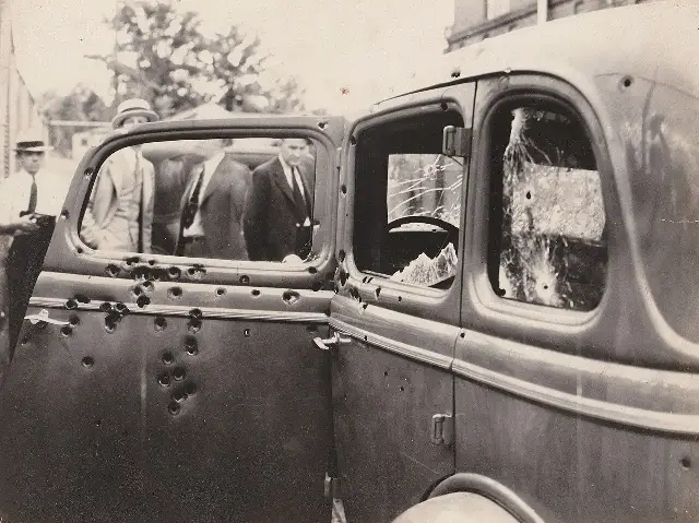 1934 photograph of Bonnie Parker and Clyde Barrow's bullet-riddled Ford V-8 after the Louisiana ambush.
