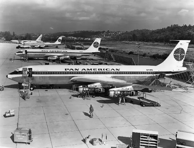 Three Pan Am Boeing 707 airliners parked on an airport tarmac in the 1960s