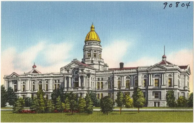 A vintage postcard-style view of the Wyoming State Capitol building in Cheyenne with its gold dome.