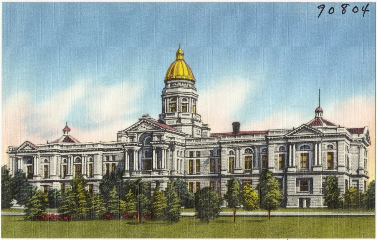 A vintage postcard-style view of the Wyoming State Capitol building in Cheyenne with its gold dome.