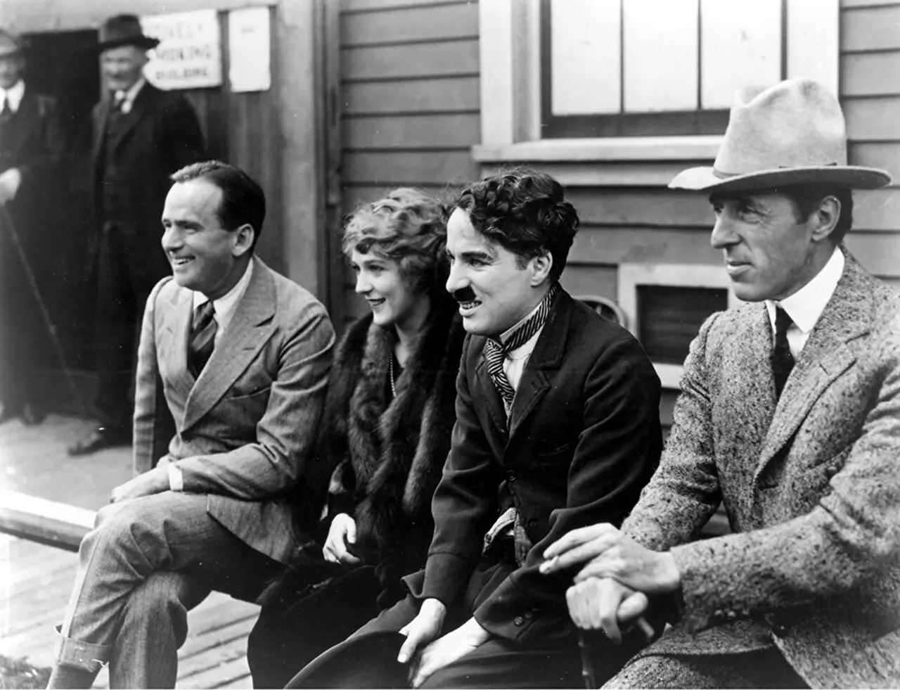 Douglas Fairbanks, Mary Pickford, Charlie Chaplin and D. W. Griffith seated together in a 1919 photograph