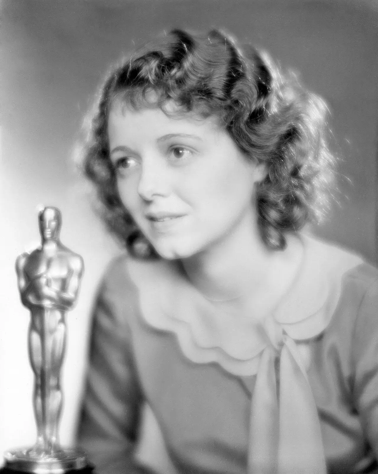Janet Gaynor holding her Best Actress Oscar at the 1st Academy Awards ceremony on May 16, 1929 (Academy photograph).