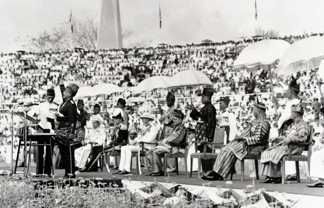 Tunku Abdul Rahman proclaiming Malaya's independence at Stadium Merdeka on August 31, 1957, before the Malay rulers and a crowd of thousands.