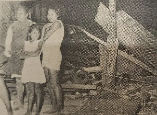 A 1972 photograph of earthquake survivors standing amid the rubble of destroyed buildings in Managua, Nicaragua