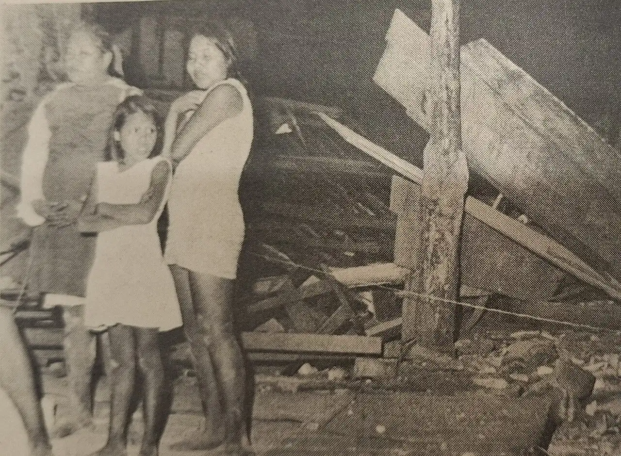 A 1972 photograph of earthquake survivors standing amid the rubble of destroyed buildings in Managua, Nicaragua