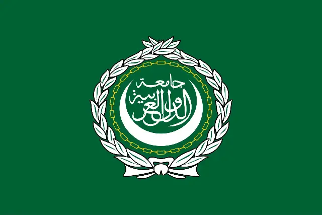 The green flag of the Arab League with its white emblem of a crescent and Arabic calligraphy inside a wreath.