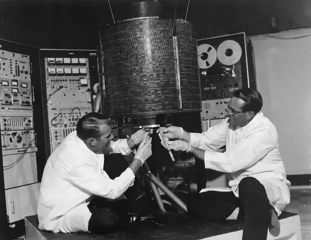 Technicians prepare the Intelsat I (Early Bird) communications satellite before its 1965 launch.