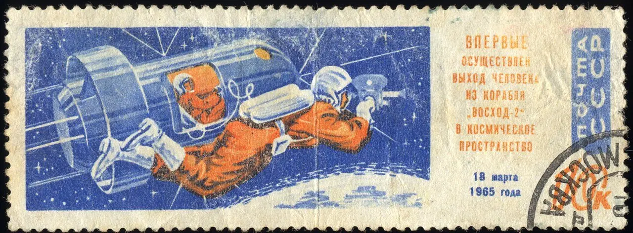1965 Soviet 10-kopek postage stamp depicting cosmonaut Alexei Leonov floating outside the Voskhod-2 spacecraft during the first spacewalk on March 18, 1965.